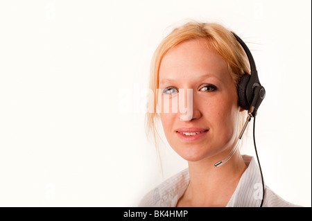 Blonde female Customer Services d personne portant un casque téléphonique smiling modèle entièrement libéré Banque D'Images