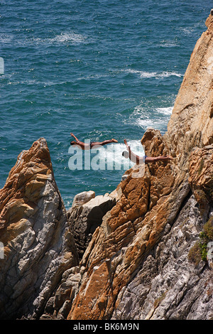 Deux plongeurs faire un «plongée wan' désactivé les célèbres falaises de la Quebrada dans l'océan turbulent ,Baie de Acapulco, Mexique Banque D'Images