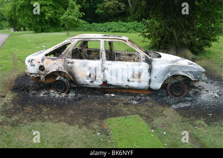 Burnt Out épave de voiture en stationnement Banque D'Images