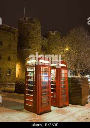 Des cabines téléphoniques et Westgate Towers couvertes de neige à Canterbury, Kent, UK. Banque D'Images