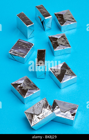 10 cubes déjoué d'argent sur un fond bleu Banque D'Images