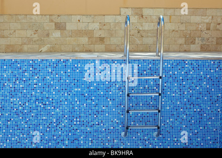 Sol carrelé bleu piscine vide sur une journée ensoleillée sans eau Banque D'Images