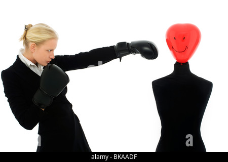 Portrait of a young caucasian businessman wearing boxing gloves air agressif et les poinçons d'un mannequin Banque D'Images