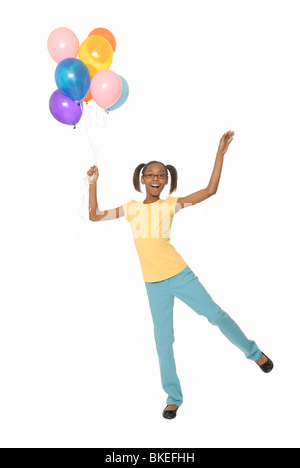 Dix ans, fille holding balloons. Banque D'Images