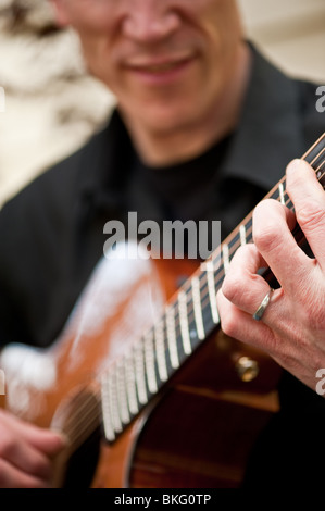 Une vue en gros plan de ses mains sur sa guitare Banque D'Images