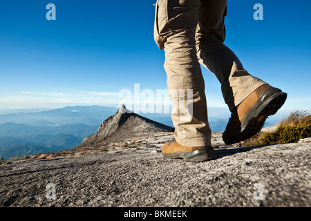 Randonneur sur Mt Kinabalu avec Pic du Sud à l'arrière-plan. Parc National de Kinabalu, Sabah, Bornéo, Malaisie. Banque D'Images