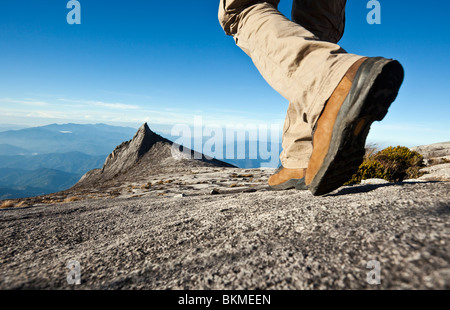 Randonneur sur Mt Kinabalu avec Pic du Sud à l'arrière-plan. Parc National de Kinabalu, Sabah, Bornéo, Malaisie. Banque D'Images