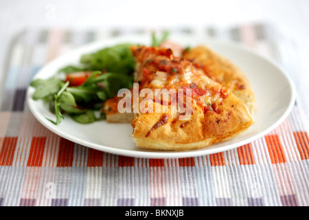 Le style italien traditionnel authentique fromage profonde et Tomato Pizza avec une salade et pas de personnes Banque D'Images