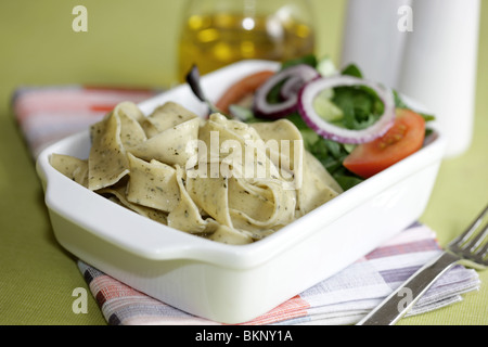 Végétarien fraîchement préparés ou cuits Pâtes Pappardelle avec un mélange de salade du jardin et basilic herbes dans un déjeuner bol avec aucun peuple Banque D'Images