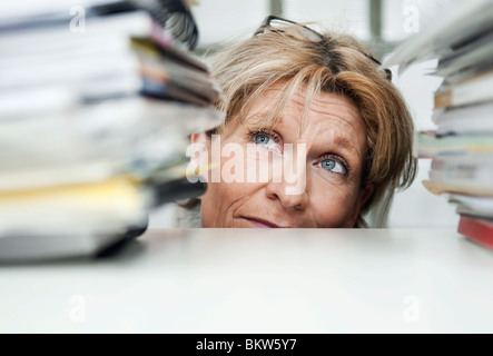 Femme entre pile of books Banque D'Images