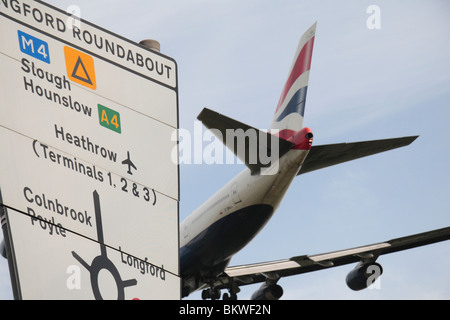 British Airways 747 un passant un panneau routier à l'atterrissage à l'aéroport de Heathrow, Londres, Royaume-Uni. Banque D'Images