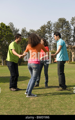 Amis jouant dans un parc Banque D'Images
