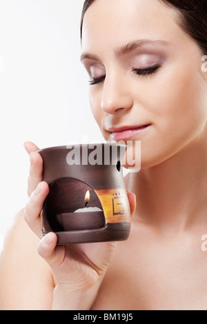 Woman smelling un brûleur d'encens Banque D'Images