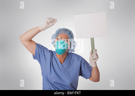 Female doctor holding a blank placard Banque D'Images