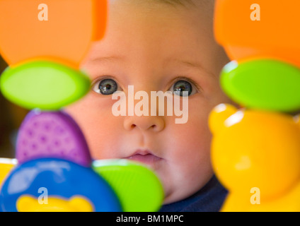Bebe Fille 6 Mois Du Tout Petit Avec Des Yeux Bleus A La Recherche Par Le Biais De Jouets En Plastique Photo Stock Alamy