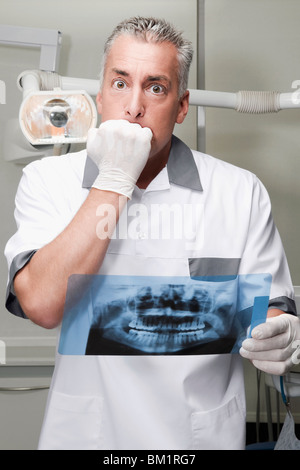 Dentiste l'examen d'une X-Ray report Banque D'Images