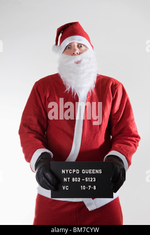 Santa Claus qui pose pour un mug shot Banque D'Images