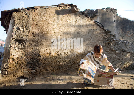 La lecture de l'homme rural journal de langue hindi l'alphabétisation dans le village urbain semi ; Dilwara Udaipur Rajasthan ; Inde ; Banque D'Images