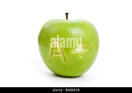 La pomme verte et un signe plus, Concept de l'apprentissage Banque D'Images