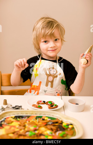 Petit boy making cookies Banque D'Images