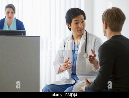 Doctor talking to patient in waiting room Banque D'Images