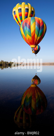 Ballons flottant au-dessus de lac calme. Banque D'Images