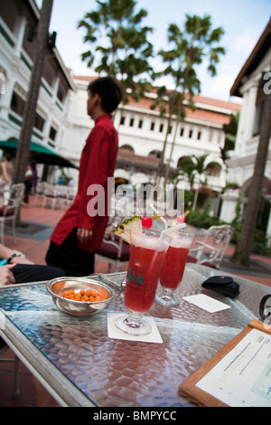 Deux verres de la célèbre Singapore Sling cocktails au Raffles Hotel, Singapore. Banque D'Images