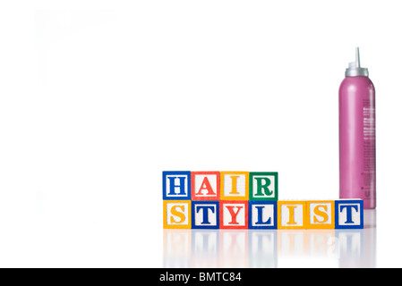 Enfants colorés blocks spelling styliste de cheveux avec hair mousse Banque D'Images