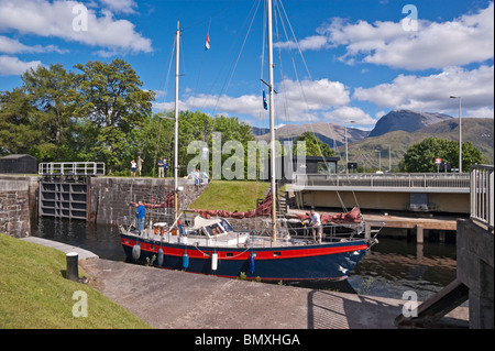 Un yacht est en passant par le Canal Calédonien à Banavie Fort William avec l'A830 road ouvert le pont tournant Banque D'Images