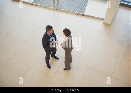 Business Woman and business man standing in office building Banque D'Images