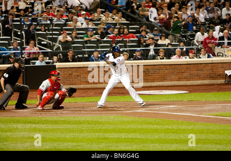 Jose Reyes a propos de bat une balle avec Carlos Ruiz attraper au Citi Field Park dans le Queens, New York. Banque D'Images