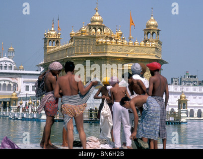 Pèlerins sikhs sécher après le bain dans le réservoir sacré entourant le temple d'or à Amritsar, Inde, Banque D'Images