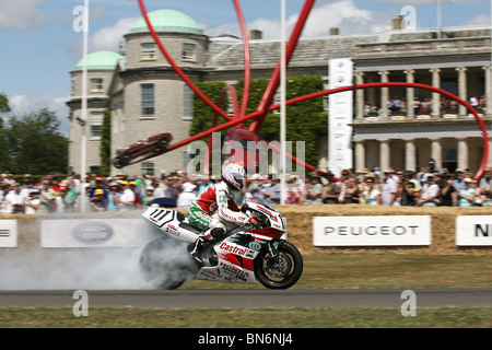 World Superbike Honda rider Aaron légère s'allume ses pneus à l'édition 2010 du Goodwood Festival of Speed, Goodwood House. Banque D'Images