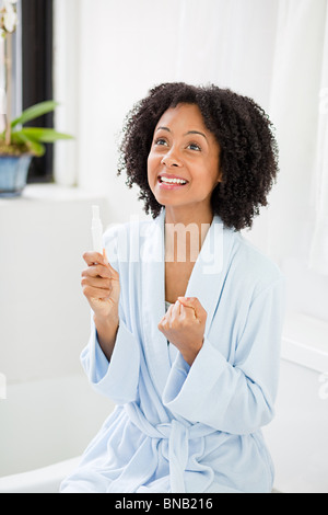 Femme joie à test de grossesse Banque D'Images