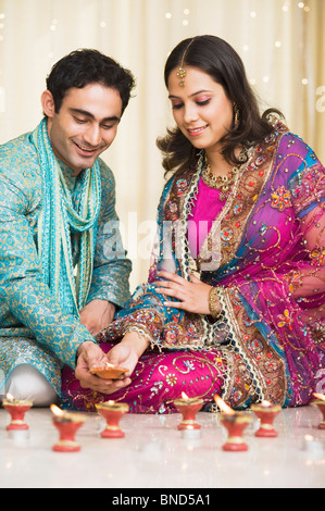 Couple decorating lampes à huile au festival du Diwali Banque D'Images