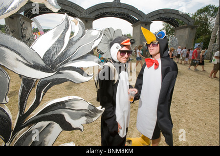 Deux hommes habillés en pingouins à l'entrée de la zone du parc à Glastonbury Festival, 2010, Angleterre, Royaume-Uni. Banque D'Images