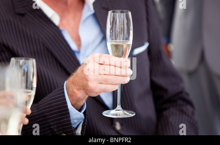 Close-up of a senior man holding a glass of Champagne Banque D'Images