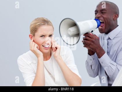 Angry businessman shouting through a megaphone Banque D'Images