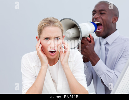 Furieux businessman shouting through a megaphone Banque D'Images