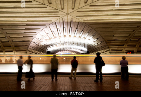 Navetteurs/passagers attendant un train sur une station de métro plate-forme alors qu'un train quitte la gare à Washington DC USA Banque D'Images