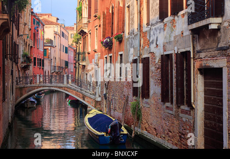 Pont et maisons à Venise, se reflétant dans un petit canal Banque D'Images