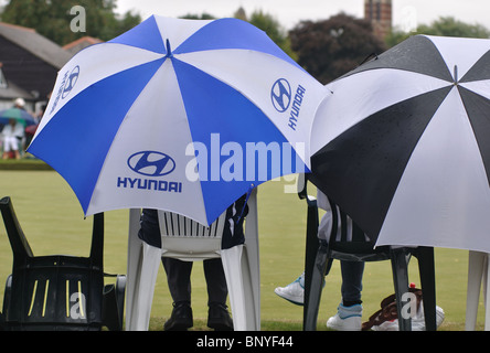 Les gens avec des parasols en regardant mes chers bols correspond à Banque D'Images