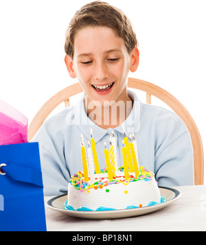 Adorable petit garçon s'apprête à souffler les bougies sur son gâteau d'anniversaire. Arrière-plan blanc. Banque D'Images