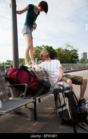 Un jeune couple s'amusant en attendant sur une plate-forme du train Banque D'Images