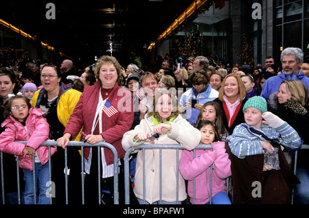 Foule de patriotes enthousiastes regardant Macy's Thanksgiving Parade dans la rue à Midtown Manhattan New York. Drapeau américain. Banque D'Images