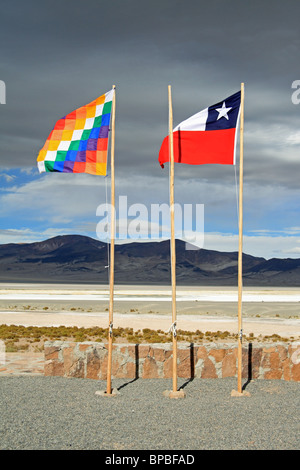 Drapeaux du Chili et de l'Aymara au Salar del Huasco salt lake, avec les montagnes des Andes derrière, Tarapaca Province, le nord du Chili Banque D'Images