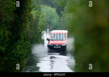 Service postal van conduisant par chemins de campagne inondée dans le district de Murton Swansea aujourd'hui au cours de la des pluies abondantes. Banque D'Images