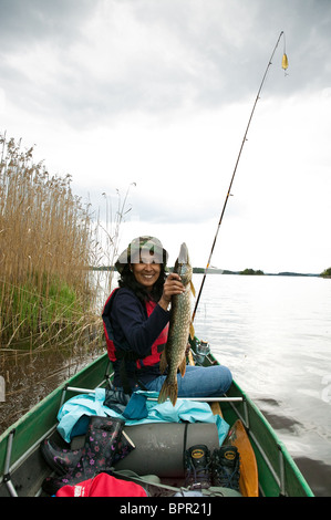 Une fille avec un grand brochet, Esox lucius, pris dans le lac Vansjø en Østfold, Norvège. Vansjø est une partie de l'eau appelé système Morsavassdraget. Banque D'Images