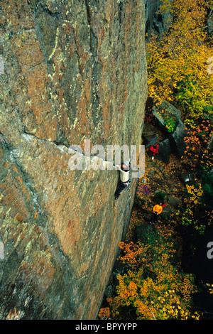 Male rock climber dans les Adirondacks avec des couleurs d'automne Banque D'Images