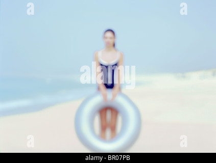 Hors focale causasian femme sur une plage portant un maillot bleu et la tenue d'un bleu lumineux robotniks. Banque D'Images